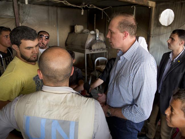 Life goes on ... Peter Dutton talks to bakery owner inside the Za’atari refugee camp in Jordan. Picture: Ella Pellegrini