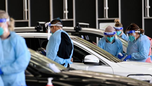 Health workers collect patient information at the Fairfield Showground Sypath Drive-through Clinic in Sydney. Picture: NCA NewsWire/Bianca De Marchi