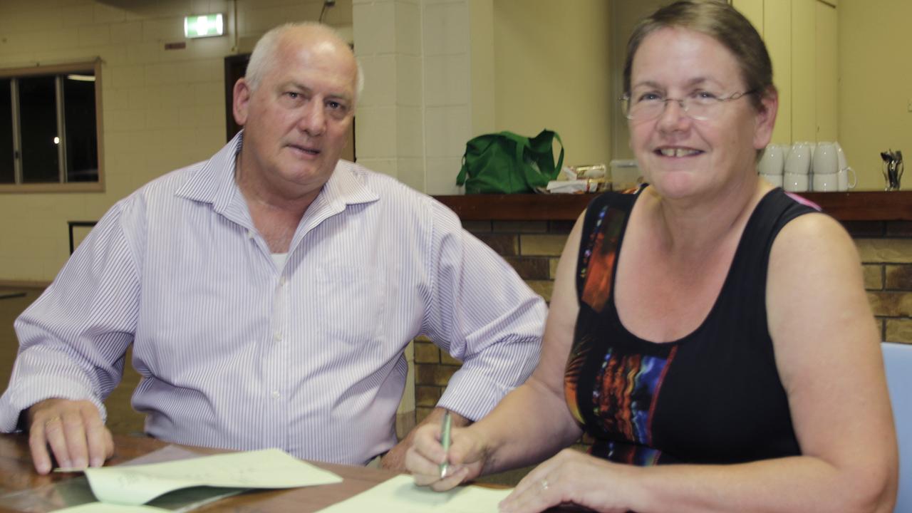 Innisfail Feast of the Senses committee president Nev Smith and Kirsty Densmore sign the contract appointing Ms Densmore as event manager.