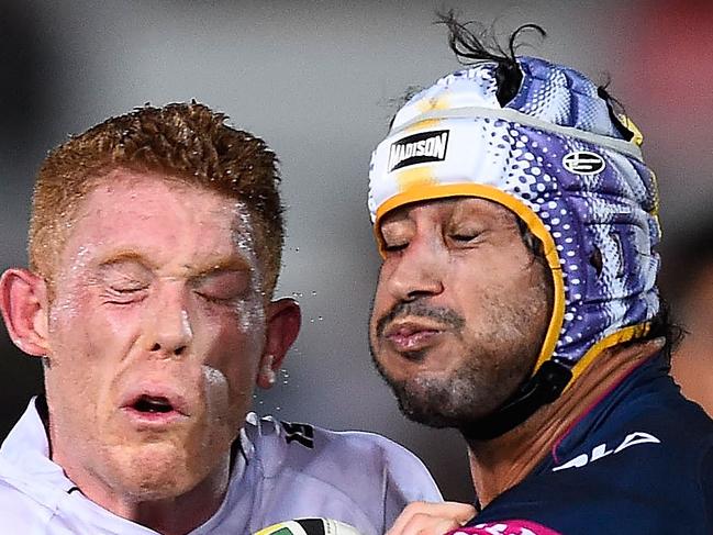 TOWNSVILLE, AUSTRALIA - MAY 30: Tom Symonds of the Sea Eagles is tackled by Johnathan Thurston of the Cowboys during the round 12 NRL match between the North Queensland Cowboys and the Manly Sea Eagles at 1300SMILES Stadium on May 30, 2015 in Townsville, Australia. (Photo by Ian Hitchcock/Getty Images)