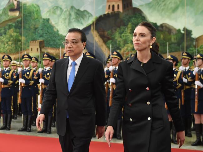 New Zealand Prime Minister Jacinda Ardern (R) reviews a military honour guard with Chinese Premier Li Keqiang at the Great Hall of the People in Beijing in 2019. Picture: AFP.