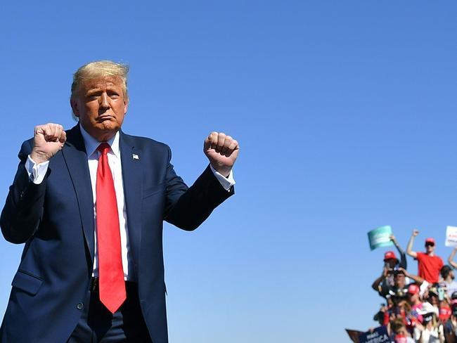 (FILES) In this file photo taken on October 19, 2020 US President Donald Trump gestures on stage during a rally at Prescott Regional Airport in Prescott, Arizona. - When Donald Trump looks down for the last time from his helicopter over the White House lawn on January 20, 2021, the wreckage of his presidency will be inescapable. The showman with the dyed blond hair, fake tan and a knack for connecting with crowds took office four years ago, making the startling promise in his inaugural speech that he would end "American carnage." (Photo by MANDEL NGAN / AFP)