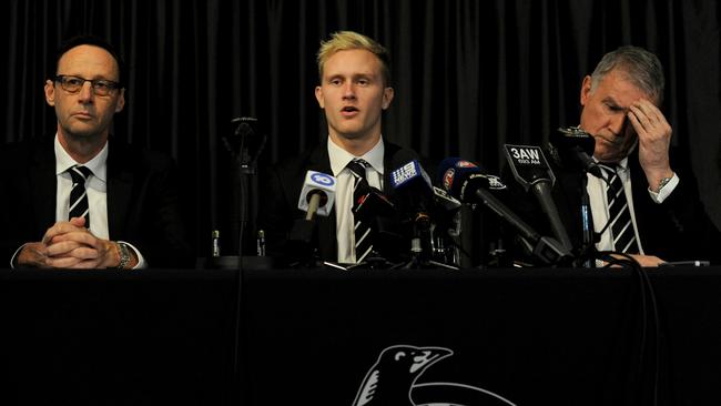 Stephenson speaks to the media next to Magpies CEO Mark Anderson (left) and football boss Geoff Walsh (right). Picture: Andrew Henshaw