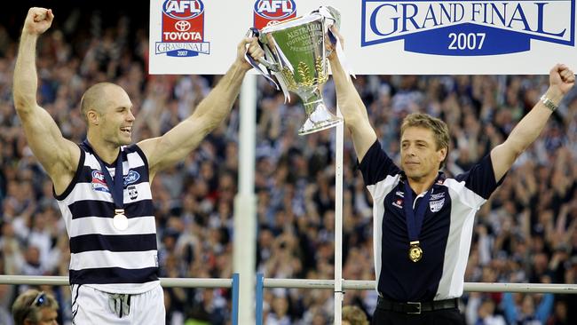 Geelong captain Tom Harley and coach Mark Thompson hold the premiership cup after the 2007 grand final triumph over the Power.