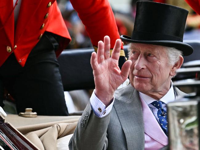 Britain's King Charles III waves as he arrives by carriage during the Royal Procession to attend the fourth day of the Royal Ascot horse racing meeting, in Ascot, west of London, on June 21, 2024. (Photo by Ben Stansall / AFP)