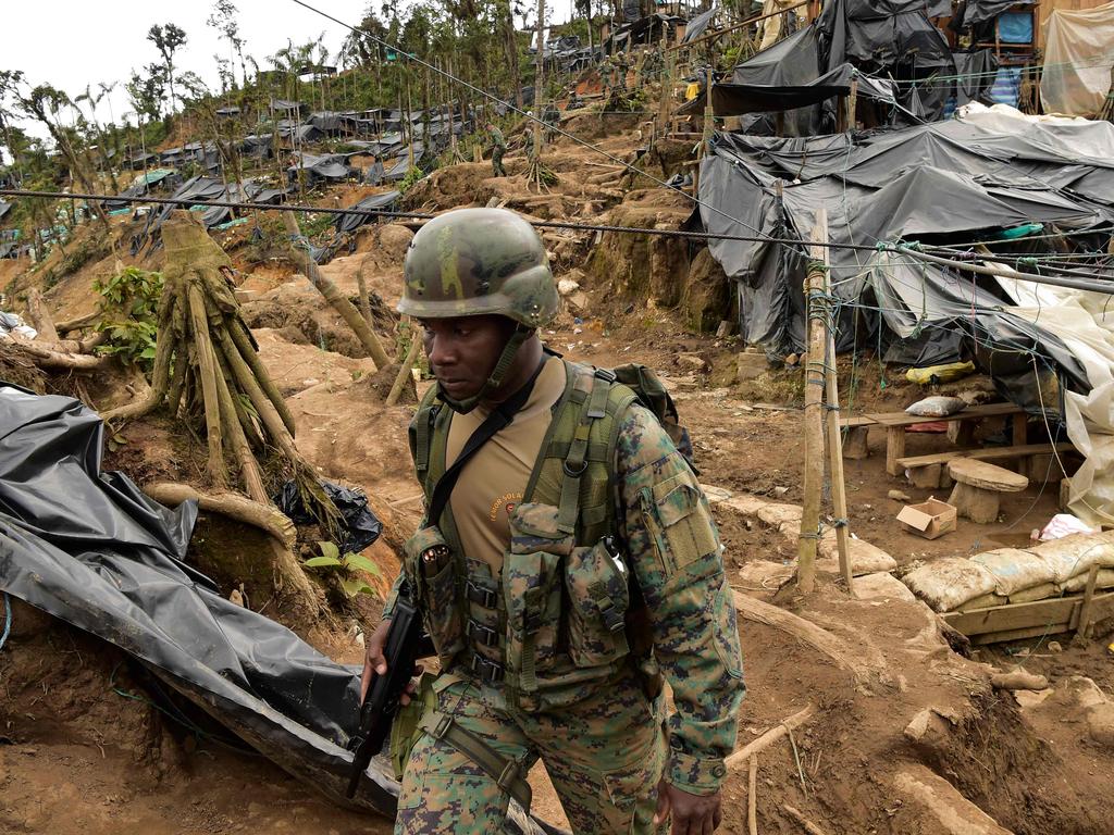 A soldier patrols in the mining area known as Mina Vieja in the parish of La Merced de Buenos Aires, Ecuador. Photo by Rodrigo BUENDIA / AFP)