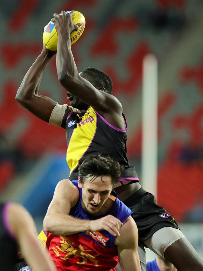 Mabior Chol flies over Oscar McInerney to mark.