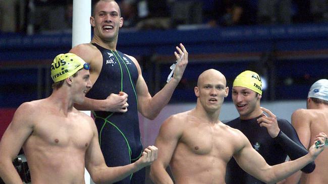 Sydney Olympics 2000: (L-R) Australia's Chris Fydler, Ashley Callus, Michael Klim and Ian Thorpe play air guitar after victory in 4x100m relay final.