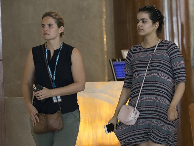 Rahaf Mohammed Alqunun, right, walks with an unidentified companion in Bangkok, Thailand, Friday, Jan. 11, 2019. Alqunun, the 18-year old Saudi woman who fled her family to seek asylum, remains in Thailand under the care of the U.N. refugee agency as she awaits a decision by a third country to accept her as a refugee. (AP Photo/Sakchai Lalit)