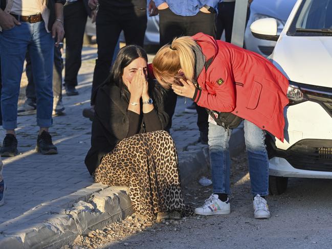 People gather outside the site of the attack. Picture: AP