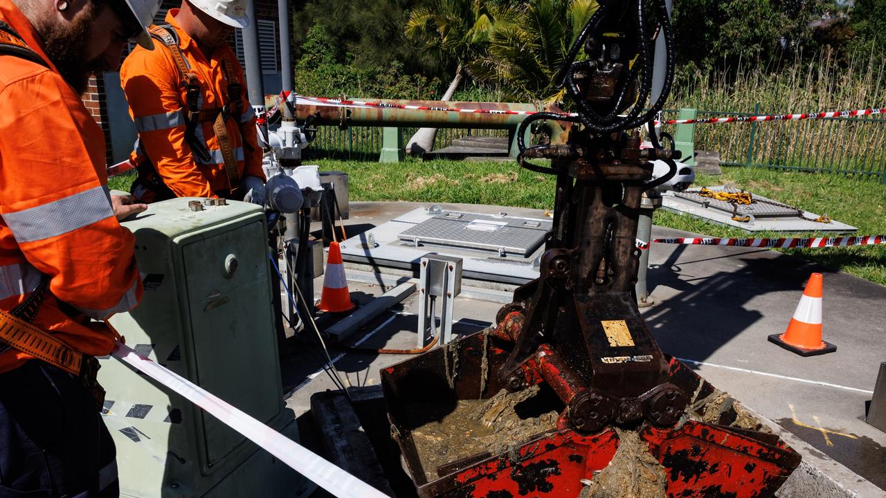 Workers at Sydney Water pull out a fatberg that has been clogging up a sewage pipe.