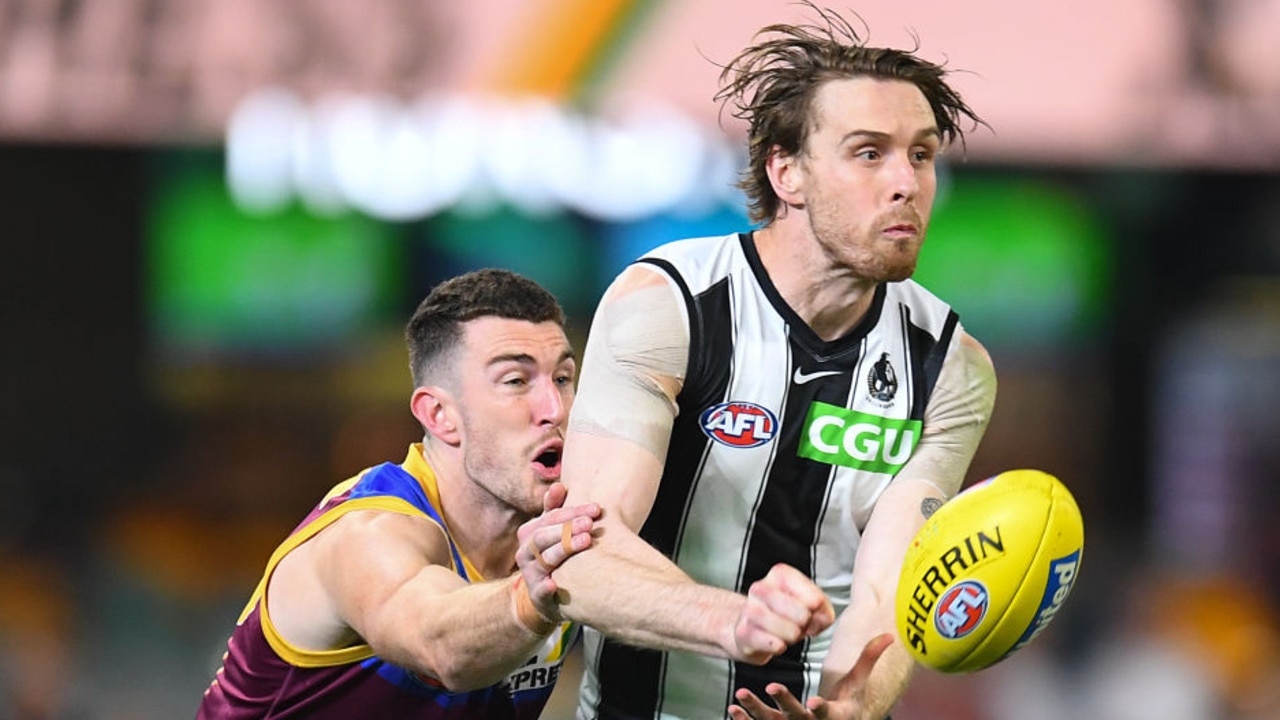 BRISBANE, AUSTRALIA - AUGUST 14: Jordan Roughead of the Magpies handballs under pressure during the round 22 AFL match between Brisbane Lions and Collingwood Magpies at The Gabba on August 14, 2021 in Brisbane, Australia. (Photo by Albert Perez/AFL Photos via Getty Images)