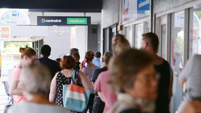 People queue outside Centrelink in Nundah, Brisbane. Picture: AAP Image/Claudia Baxter.