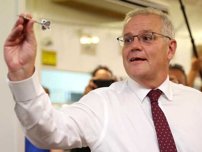 CAIRNS, AUSTRALIA - MAY 16: Prime Minister Scott Morrison plays darts during a visit to meet local community members at Railway Halls on May 16, 2022 in Cairns, Australia. The Australian federal election will be held on Saturday 21 May. (Photo by Asanka Ratnayake/Getty Images)