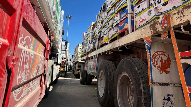 Trucks carrying humanitarian aid line up on the Egyptian side of the Rafah border crossing with Gaza after Israel suspended the entry of supplies. Picture: AFP