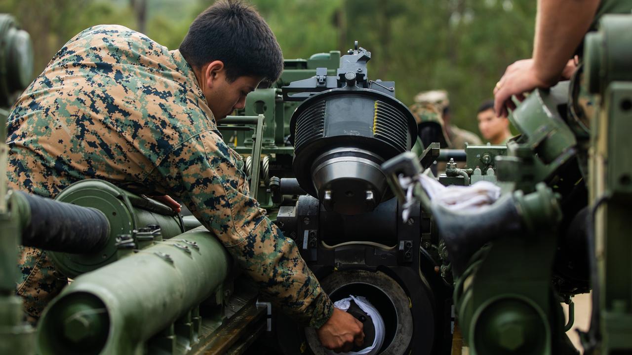 U.S. Marine Corps Cpl. Damian Garcia with 3d Battalion, 12th Marines, 3d Marine Division, cleans the tube of an M777A2 155mm Howitzer during Exercise Talisman Sabre 2021 on Shoalwater Bay Training Area in Queensland, Australia, July 14, 2021. TS21 is a large-scale, bilateral military exercise conducted biennially across Northern Australia designed to enhance the U.S.-Australia alliance which is an anchor of peace and stability in the Indo-Pacific. Exercises like this provide effective and intense training to ensure our forces are capable, interoperable, responsive, and combat-ready. Garcia is a native of Mesa, Arizona. (U.S. Marine Corps photo by Lance Cpl. Ujian Gosun)