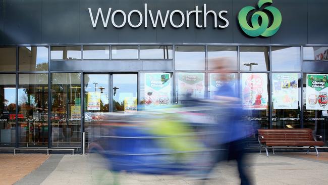 MELBOURNE, AUSTRALIA - MAY 25: A shopper walks out of Woolworths supermarket on May 25, 2015 in Melbourne, Australia. In a bid to regain its title as Australia's distinguished retailer, Woolworths are set to cut costs and reduce prices on thousands of grocery products to compete with rival supermarket giants Coles and Aldi. (Photo by Quinn Rooney/Getty Images)