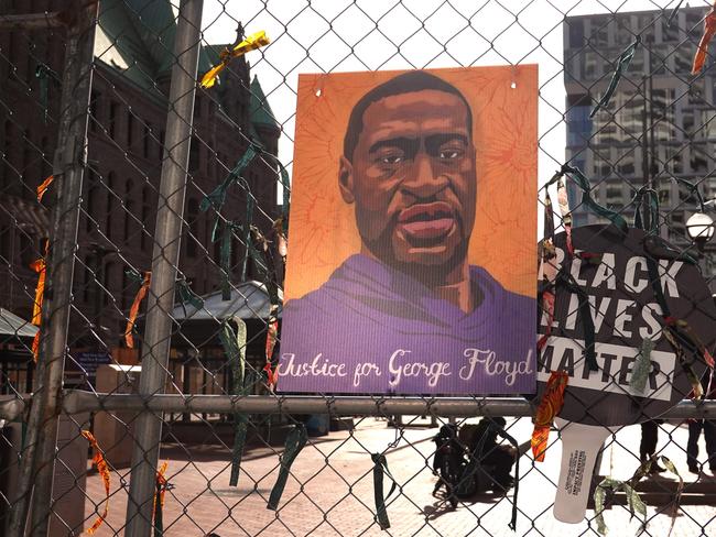 A picture of George Floyd hangs on a fence barrier near the court where Derek Chauvin is on trial. Picture: Getty Images/AFP