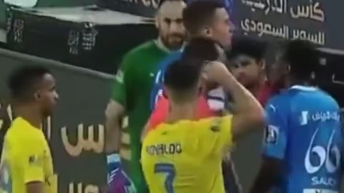 Cristiano Ronaldo raises a fist at the referee.
