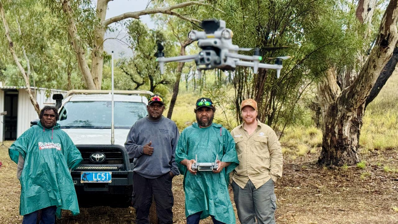 Bevan Pepperill and the Anmatyerr Rangers using a drone. Picture: Central Land Council