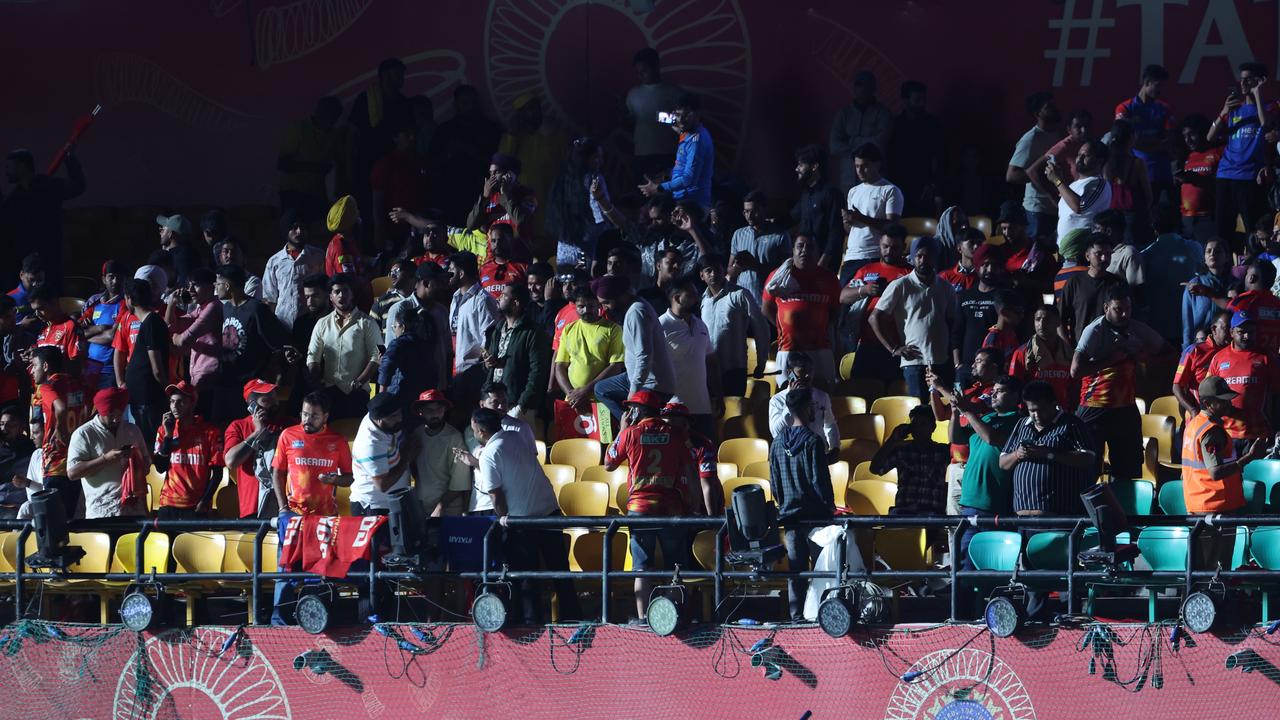 Spectators leave the stands after authorities evacuated the stadium during the 2025 IPL match between Punjab Kings and Delhi Capitals in Dharamsala, India. (Photo by Pankaj Nangia/Getty Images)
