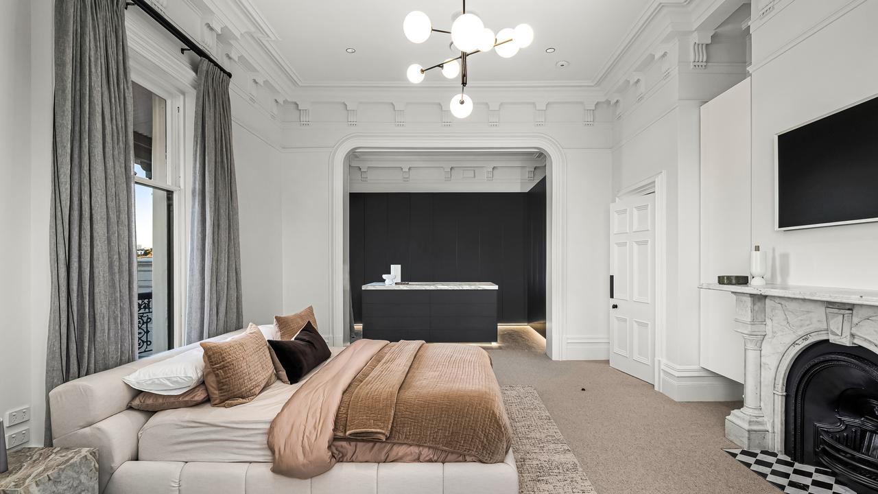 The luxurious master bedroom features a period fireplace.