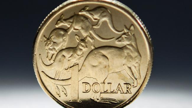 An Australian one-dollar coin is arranged for a photograph in Sydney, Australia, on Wednesday, April 17, 2013. Direct trading between the Australian dollar and yuan started on April 10. Photographer: Ian Waldie/Bloomberg