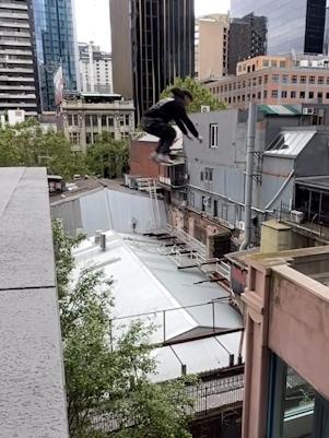 A teen leaps between buildings in Melbourne’s CBD.