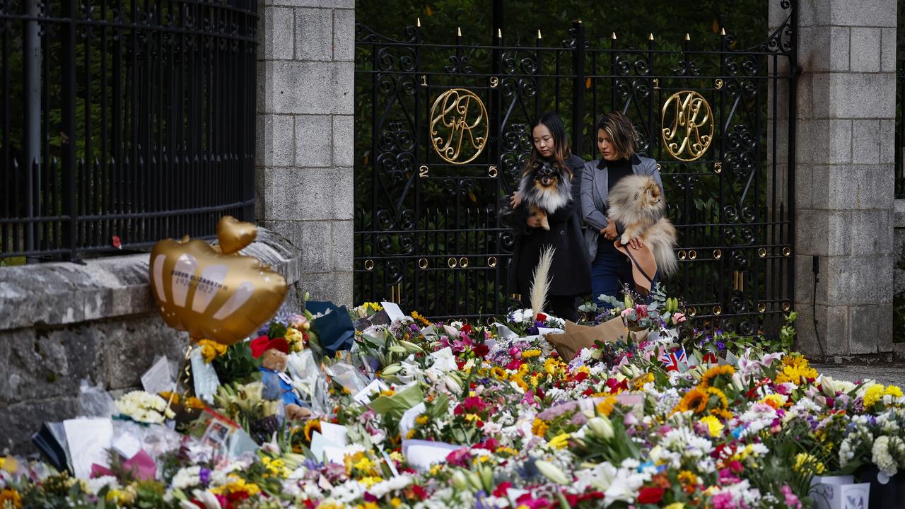 Members of the public gather at the gates of Balmoral Castle to lay floral tributes. Picture: Getty