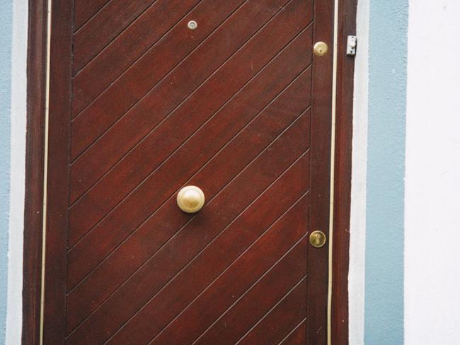 Snapshot of a letterbox on the bottom of the door in Ireland by Pauline Whinham of /Main /Beach /GC. travel mail box