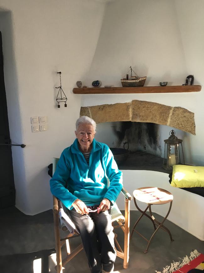 Susan’s mother, Barbara Johnson, in front of the fire at Almond Tree House, Kythera.