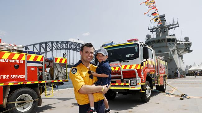 East Jindabyne RFS Volunteer Jake Roarty and son Harrison aboard HMAS Canberra on Australia Day. Picture: Nikki Short