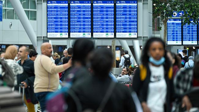 Passengers wait for check-in at the departures area of Dusseldorf International Airport. Picture: AFP