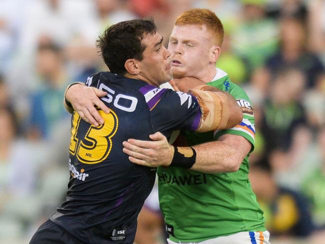 Canberra’s  Corey Horsburgh tries to wrap up Melbourne’s Dale Finucane on Friday night. Picture: AAP 