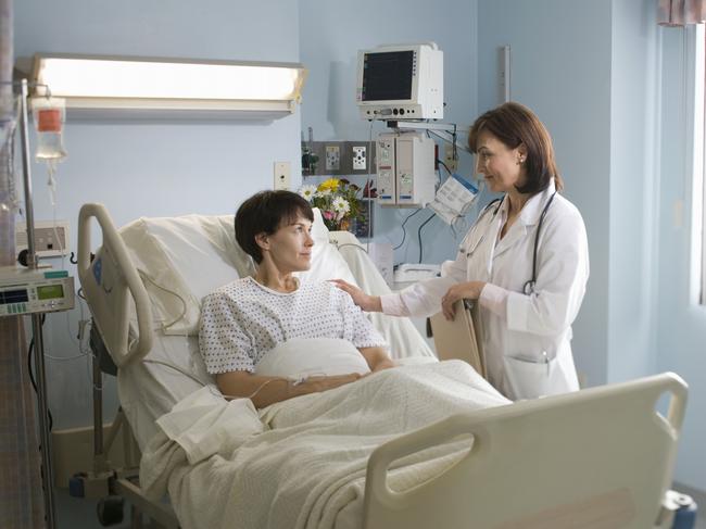 Female doctor comforting female patient lying in hospital bed. generic. Thinkstock. Picture: Supplied