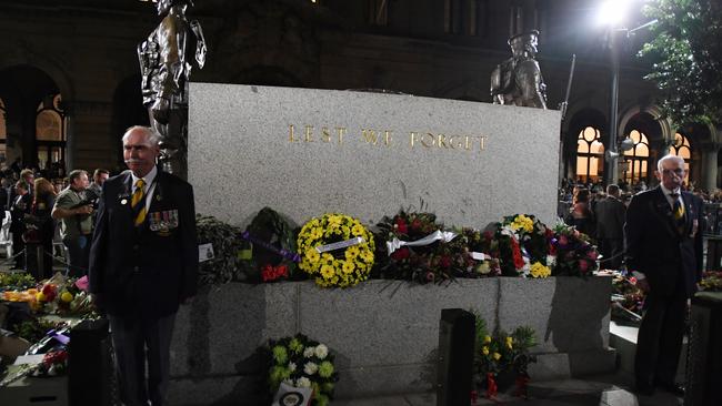 Custodians stand next to the Cenotaph after the Anzac Day Dawn service at Martin Place in Sydney. Picture: AAP.