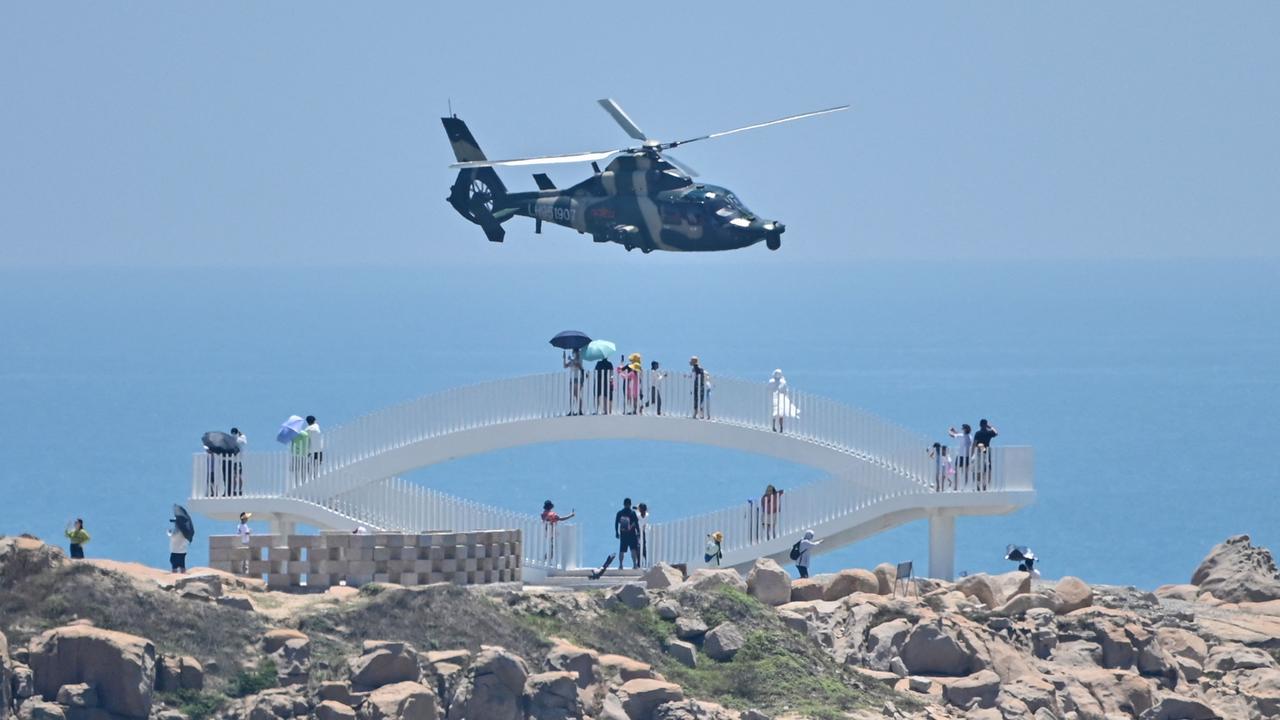 A Chinese military helicopter flying past Pingtan Island ahead of the massive military drills. Picture: Hector Retamal/AFP