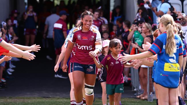 Super W’s Cecilia Smith of the Reds enters the field with daughter Ruby earlier this year.(Photo by Chris Hyde/Getty Images)