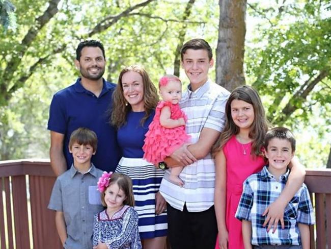 Michael Wetzel, left, is seen standing with his wife and six children in an undated photo. Picture: YOUCARING