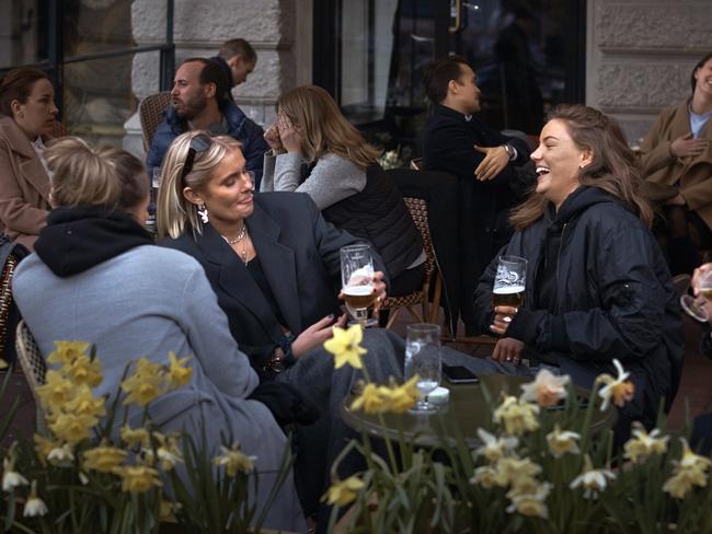 People chat and drink outside a bar in Stockholm, Sweden. Picture: AP