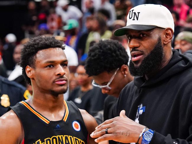 (FILES) Bronny James, #6 of the West team, talks to Lebron James, of the Los Angeles Lakers, after the 2023 McDonald's High School Boys All-American Game at Toyota Center in Houston, Texas, on March 28, 2023. Bronny James, the eldest son of NBA superstar LeBron James, is in a stable condition after suffering a cardiac arrest during a practice with his college basketball team, the James family said on July 25, 2023. (Photo by Alex Bierens de Haan / GETTY IMAGES NORTH AMERICA / AFP)