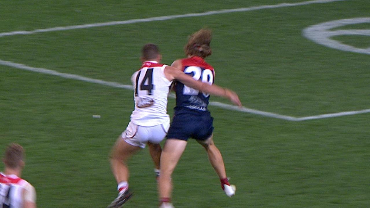 St Kilda captain Jarryn Geary lays a bump on Melbourne's Jayden Hunt.