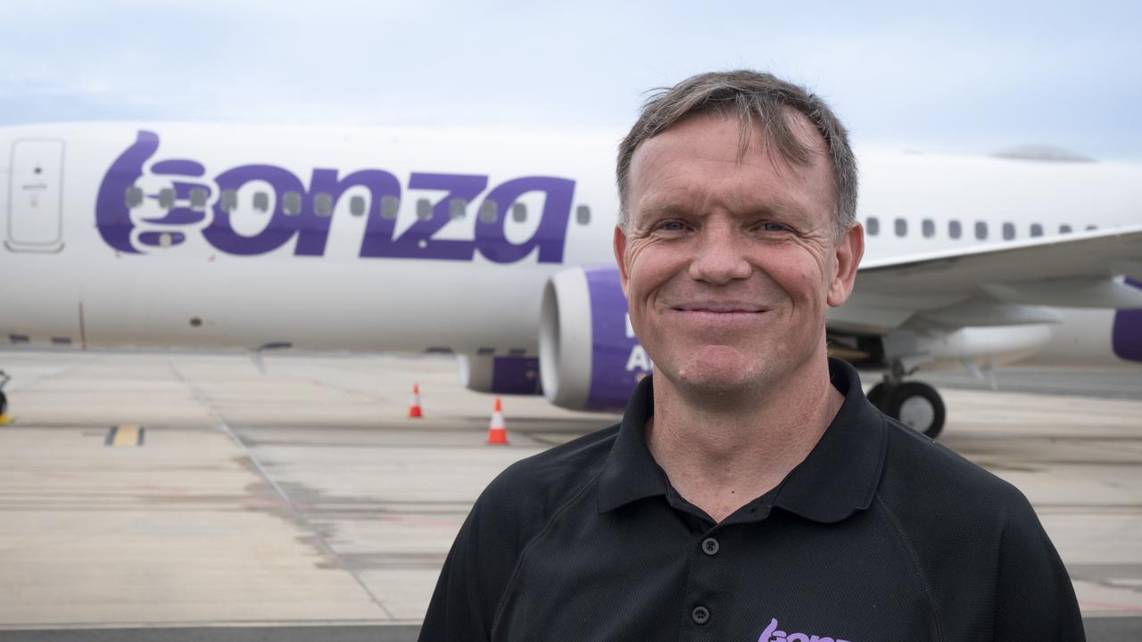 Bonza CEO Tim Jordan stands in front of the low-cost airline's first plane at Sunshine Coast Airport.