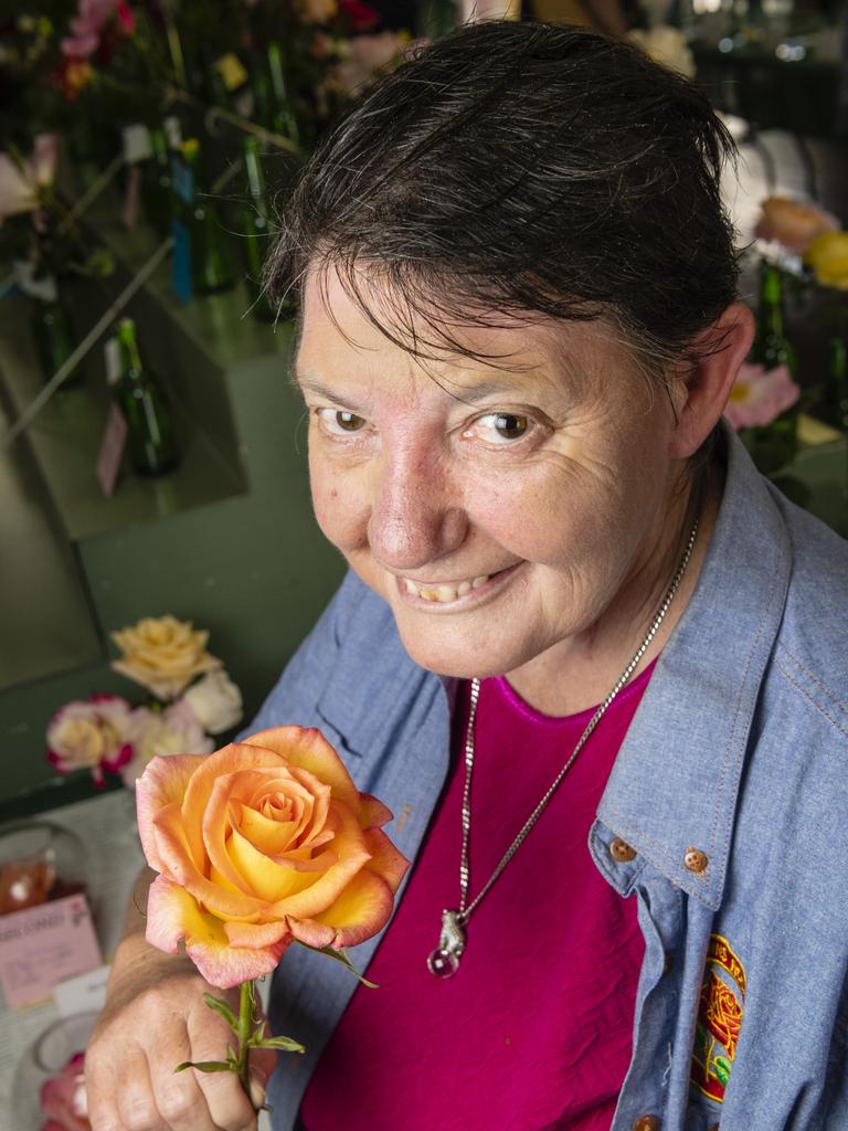 Susanne Dart shows off her hybrid tea reserve champion of the 2022 Spring Champion Rose Show at the Rose Cottage in the Queensland State Rose Garden, Saturday, October 8, 2022. Picture: Kevin Farmer