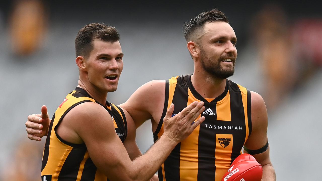 Jaeger O'Meara and Jack Gunston of the Hawks celebrate winning the round one AFL match between the Hawthorn Hawks and the North Melbourne Kangaroos at Melbourne Cricket Ground on March 20, 2022 in Melbourne, Australia.