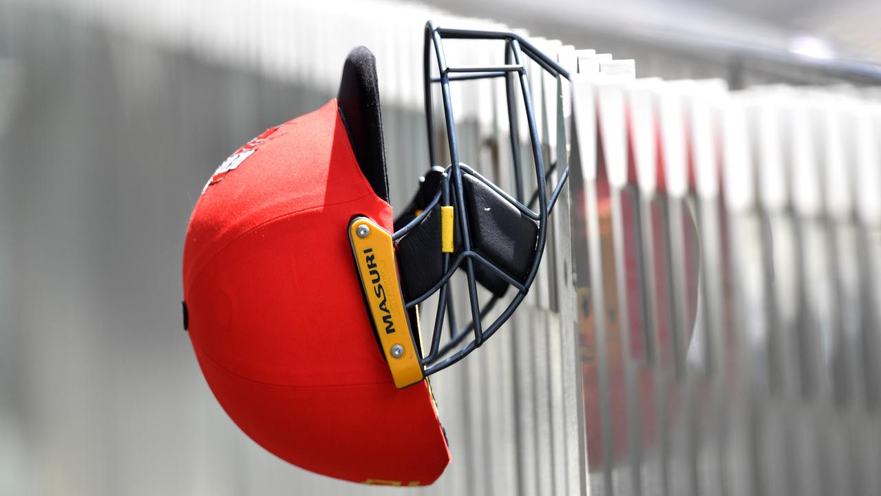 A Redbacks helmet hangs from the fence during day three of the Marsh Sheffield Shield match between South Australia and Tasmania at Adelaide Oval in Adelaide, Wednesday, November 13, 2019. (AAP Image/David Mariuz) NO ARCHIVING, EDITORIAL USE ONLY