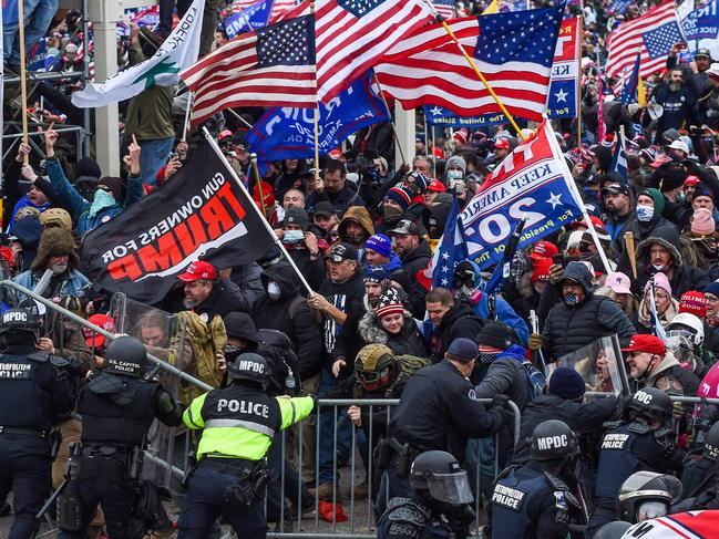 In this file photo taken on January 06, 2021, Trump supporters battle with police and security forces as they storm the US Capitol building in Washington, DC. - President Joe Biden slammed his predecessor Donald Trump Monday in a prerecorded video address to The National Organization of Black Law Enforcement Executives (NOBLE) for watching his supporters riot for hours on January 6 while police at the US Capitol suffered through a 