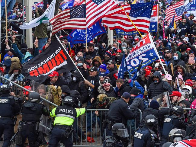 In this file photo taken on January 06, 2021, Trump supporters battle with police and security forces as they storm the US Capitol building in Washington, DC. - President Joe Biden slammed his predecessor Donald Trump Monday in a prerecorded video address to The National Organization of Black Law Enforcement Executives (NOBLE) for watching his supporters riot for hours on January 6 while police at the US Capitol suffered through a "medieval hell." (Photo by ROBERTO SCHMIDT / AFP)