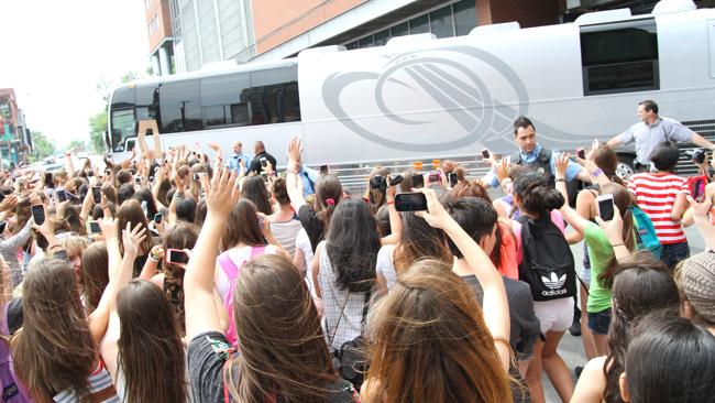 The One Direction tour bus is mobbed by screaming fans in Montreal, Canada....