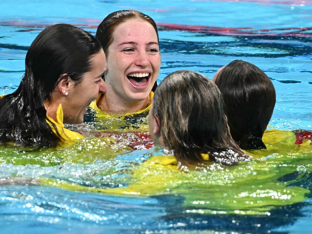 Mollie O'Callaghan, Emma Mckeon, Kaylee McKeown and Jenna Strauch are all smiles after spontaneously jumping into the pool at La Defense Arena. Picture: AFP